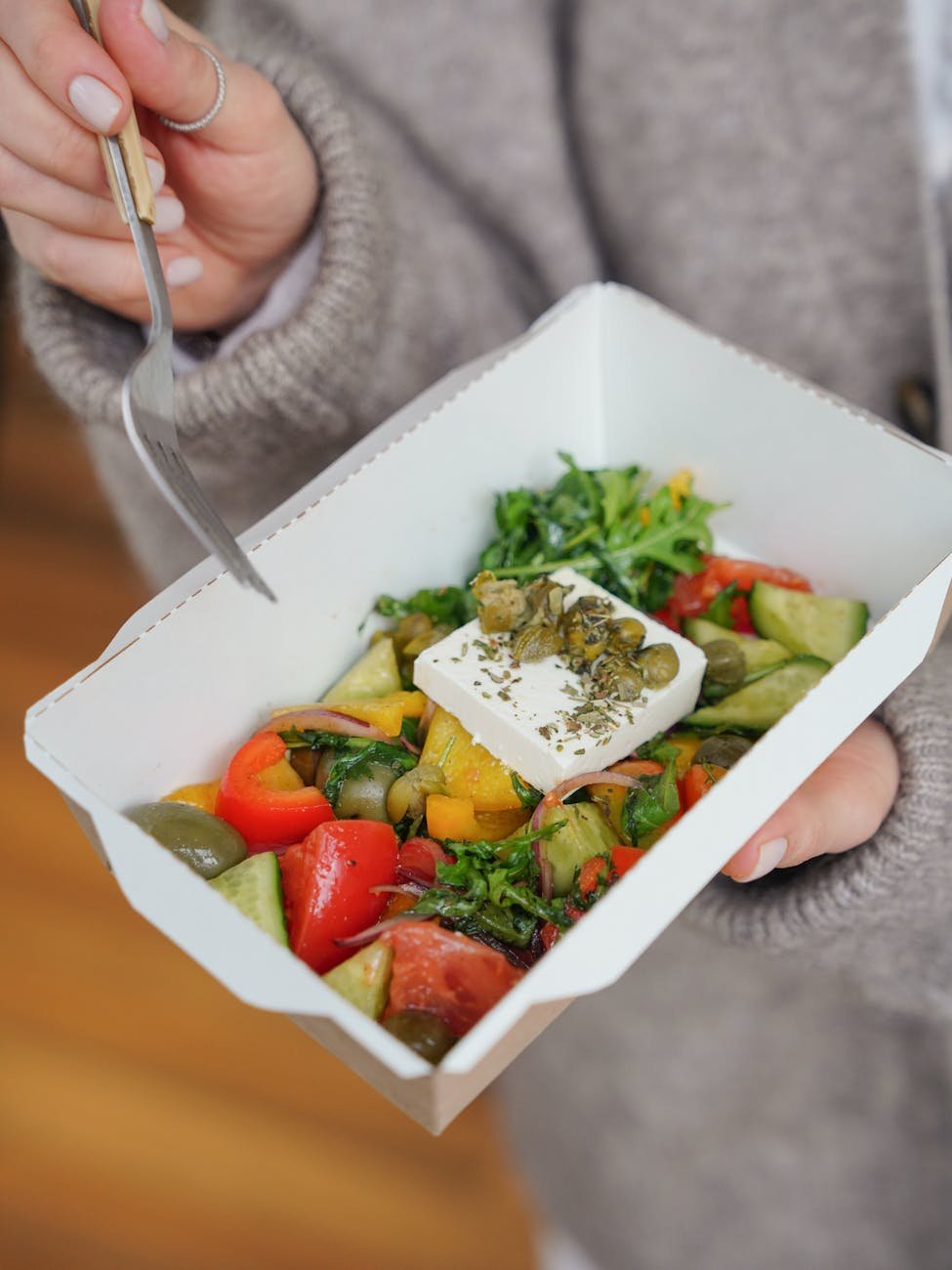 woman holding fresh salad